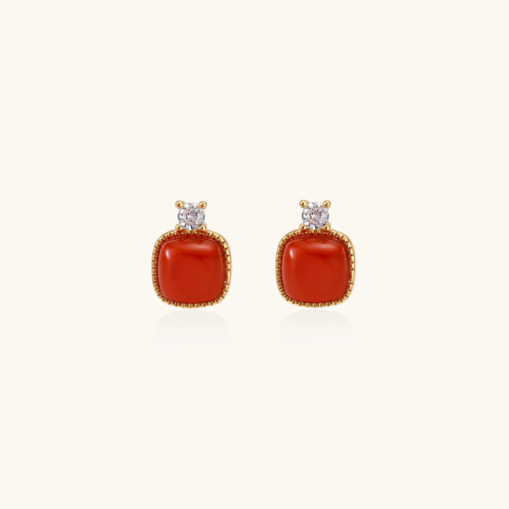 18K gold vermeil stud earrings with cushion-cut red agate stones and sparkling crystal accents on beige background