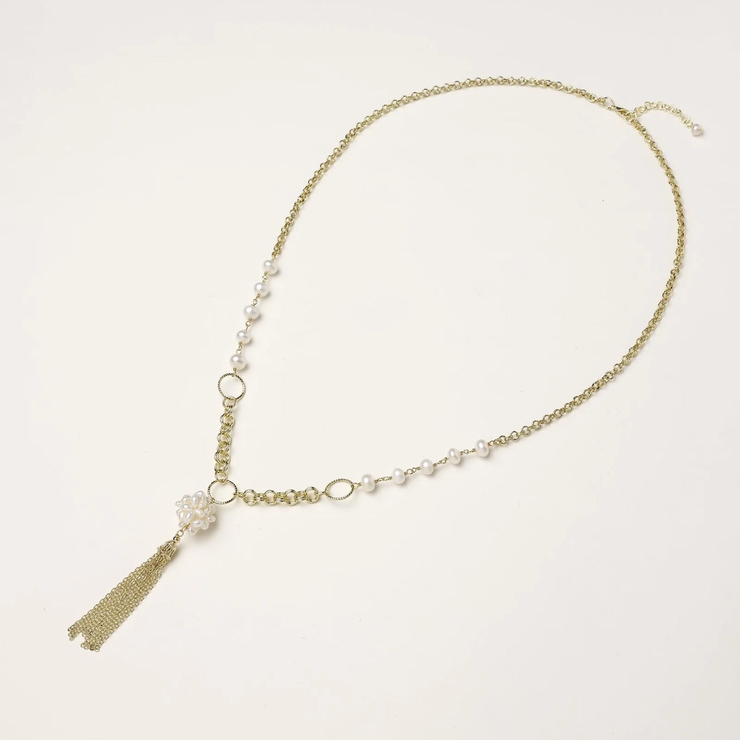 Long gold-plated necklace with freshwater pearls, chunky chain links, and flowing tassel pendant