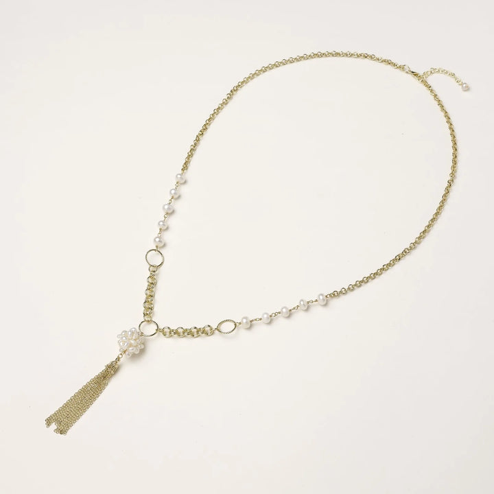 Long gold-plated necklace with freshwater pearls, chunky chain links, and flowing tassel pendant