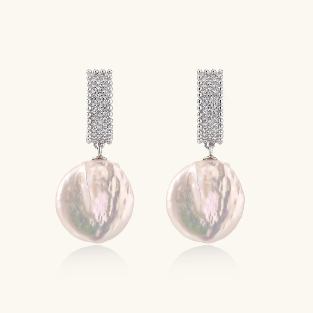 Rhodium-plated silver curved stud with pave stones and baroque pearl drop on white background