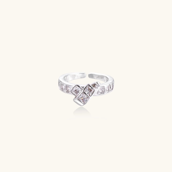 White gold plated adjustable ring featuring offset square cubic zirconia stones in an architectural stacked design