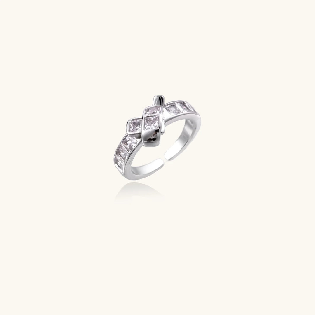 White gold plated adjustable ring featuring offset square cubic zirconia stones in an architectural stacked design