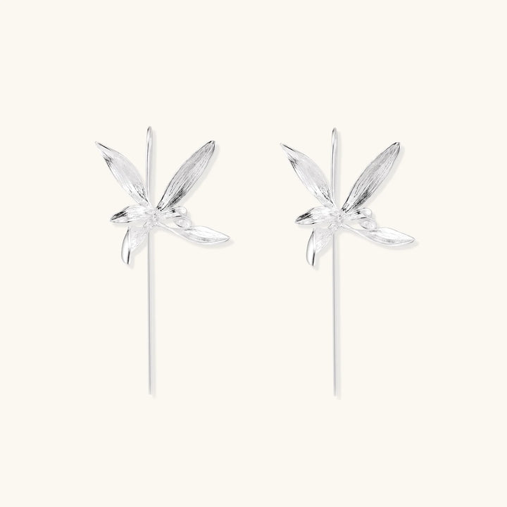 Delicate sterling silver dragonfly earrings with textured wings and curved threader hooks on white background