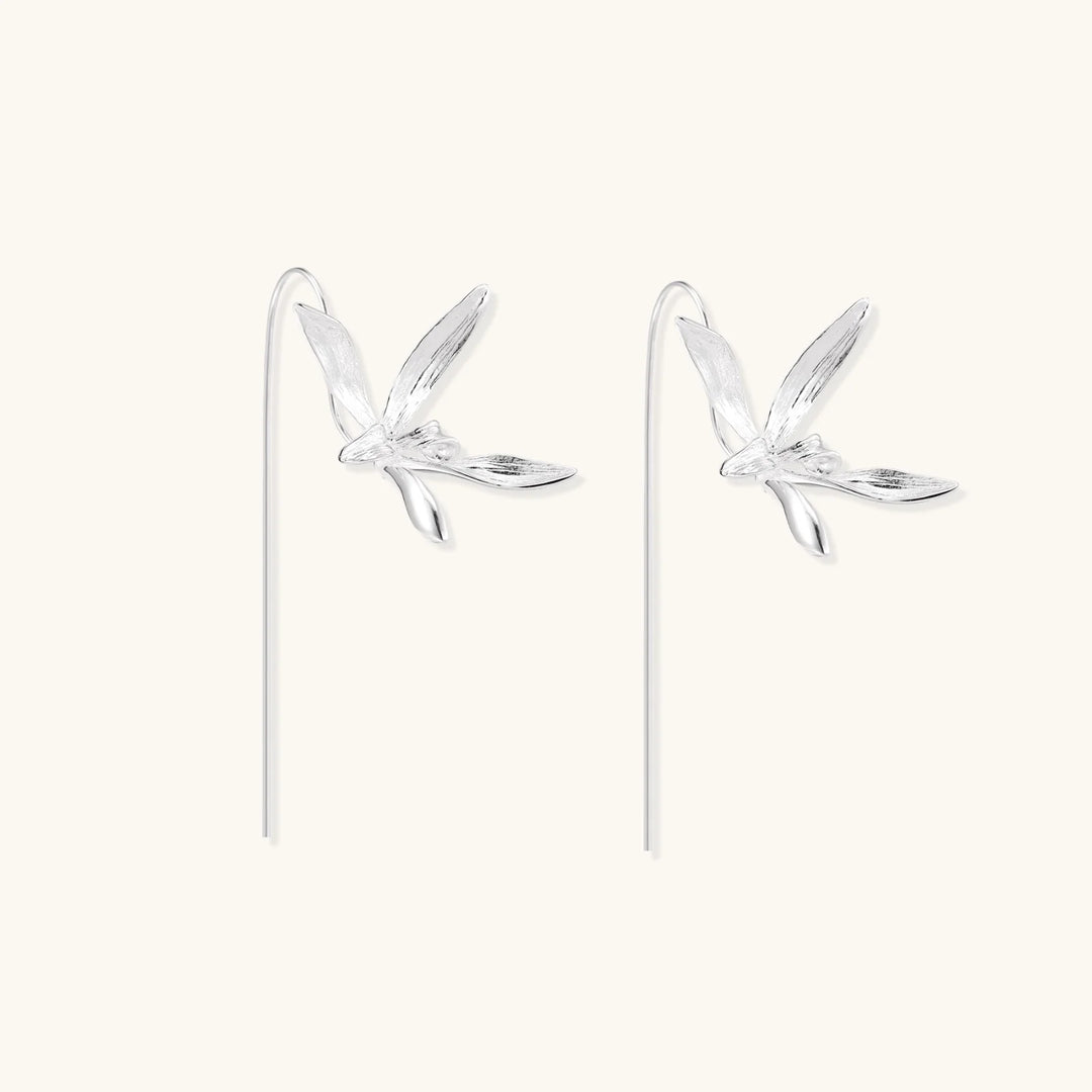 Delicate sterling silver dragonfly earrings with textured wings and curved threader hooks on white background