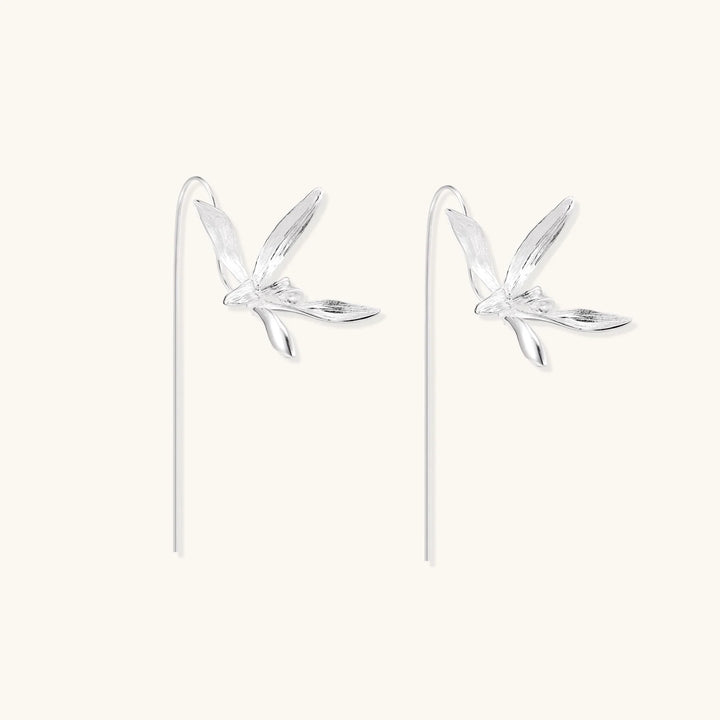 Delicate sterling silver dragonfly earrings with textured wings and curved threader hooks on white background