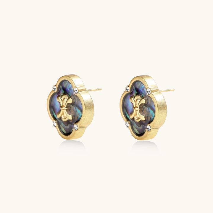 Gold quatrefoil stud earrings with iridescent abalone shell inlay and fleur-de-lis center, accented by four crystals