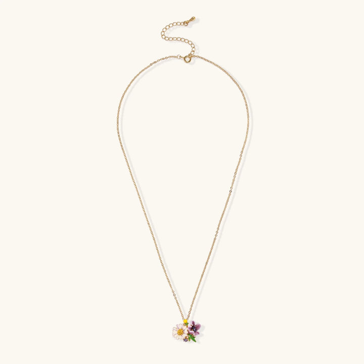 Gold-plated necklace with pink and purple enamel flower pendant featuring crystal accents on cream background