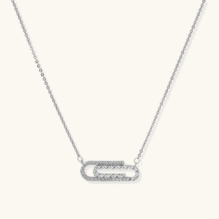 White gold plated necklace with dual-frame geometric pendant featuring crystal pavé border on pale background.