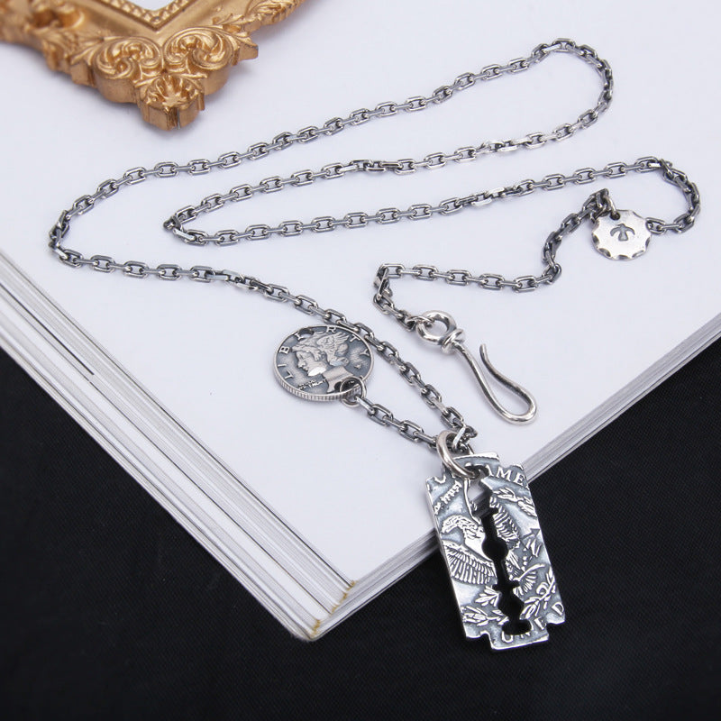 Morgan Blade 925 sterling silver geometric pendant necklace on white notebook